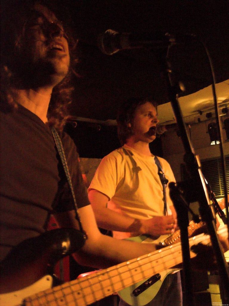 This is a music concert, a person who is wearing white color shirt is singing,there is a mike in...